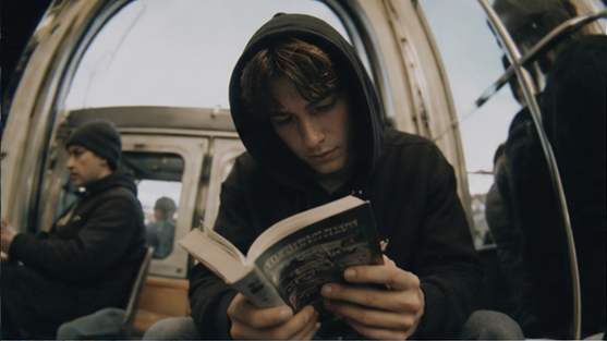 A passenger reads a book on public transport