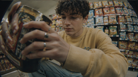 A shopper examines a product in a grocery store